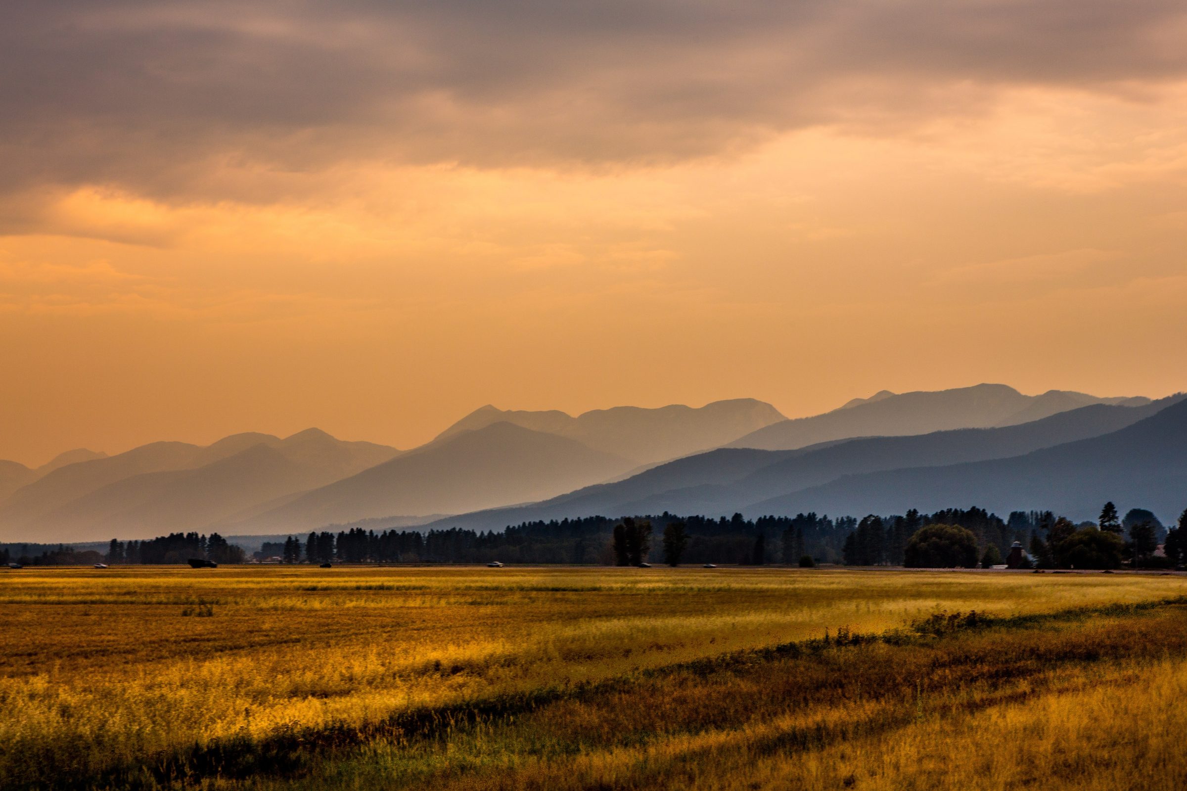 A wide rural valley at sunset